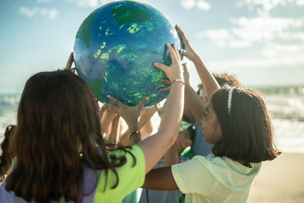 Kids holding a globe