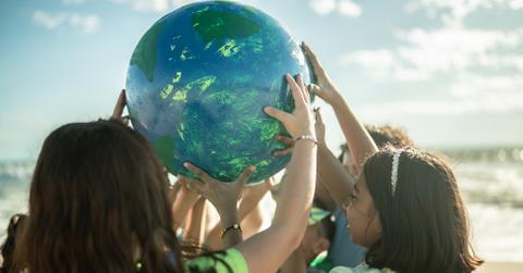 Kids holding a globe