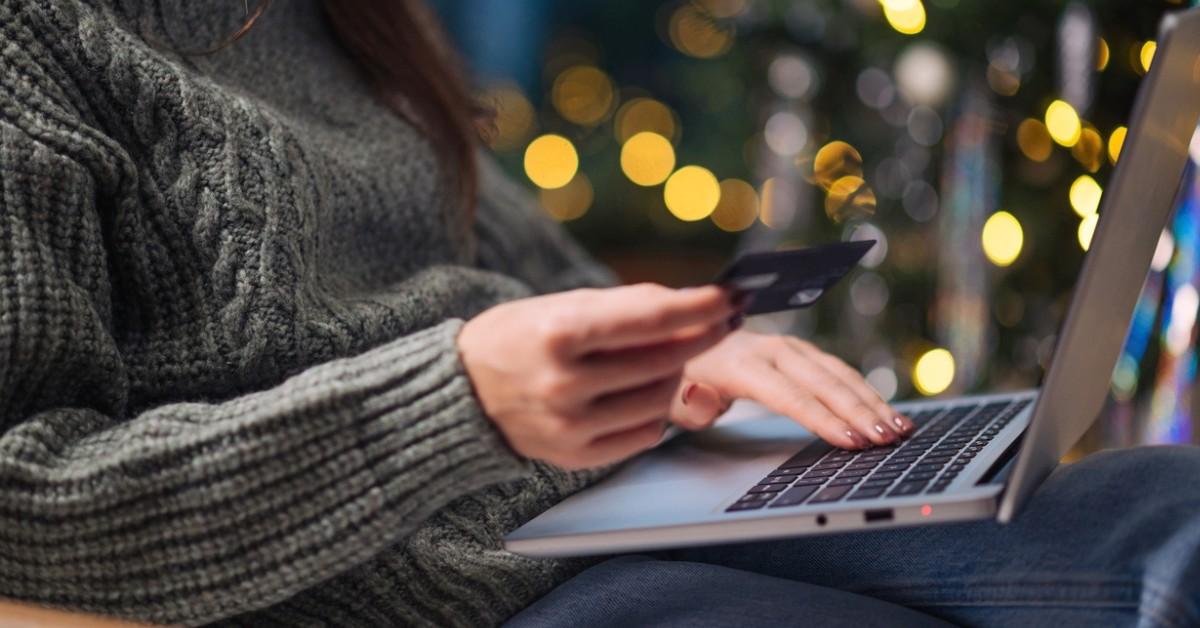 Woman uses her credit card to make an online purchase