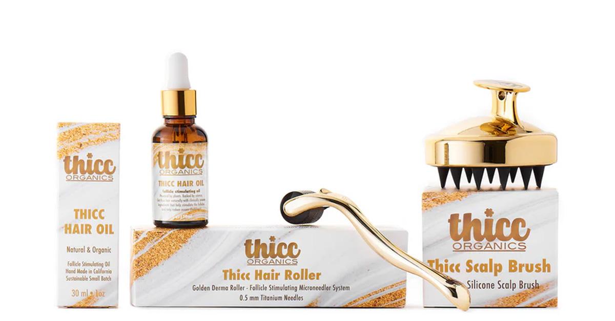 Thicc Organics hair kit with hair oil, hair roller, and scalp brush.