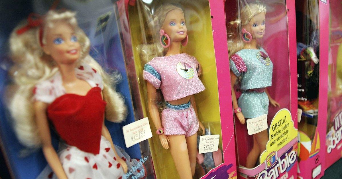 Four Barbie dolls in boxes on a store shelf