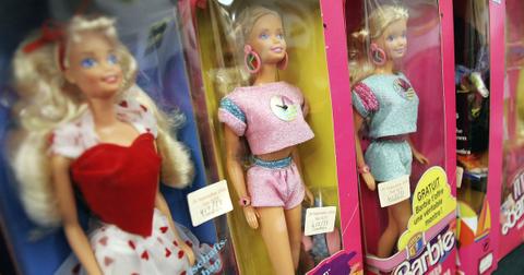 Four Barbie dolls in boxes on a store shelf