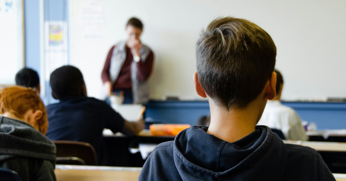 Closeup of a student's head as they sit in the back of class