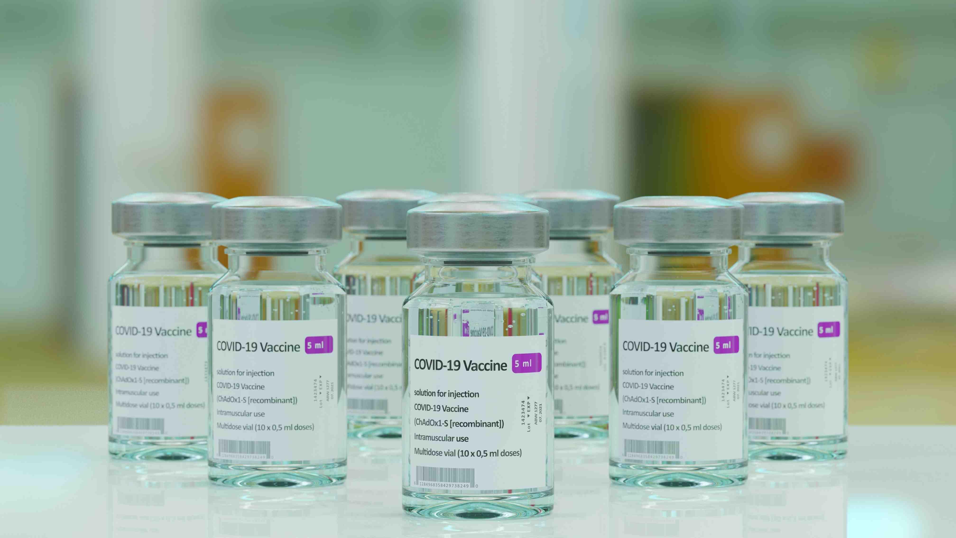 Seven vials of the COVID-19 vaccine are pictured in a lab.