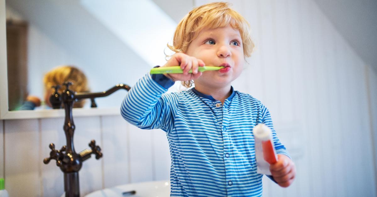 Cute little boy brushing his teeth. 