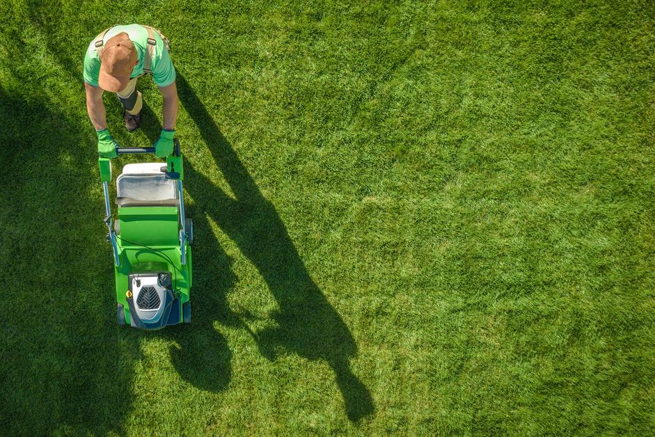 Aerial photo of a person mowing a lawn.