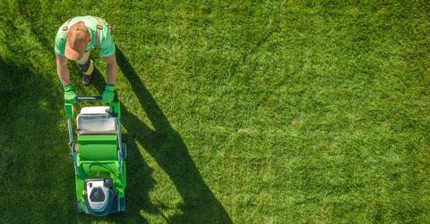 Aerial photo of a person mowing a lawn.