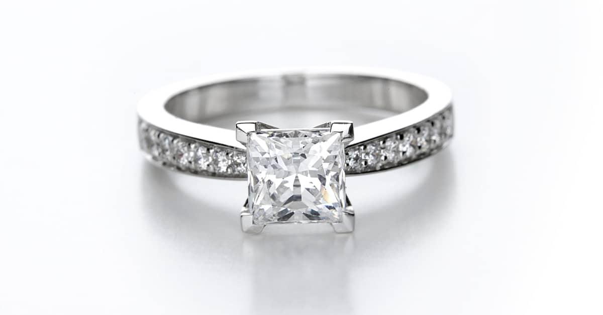 Beautiful engagement ring with a large diamond in the centre piece and tiny diamonds all around the band.