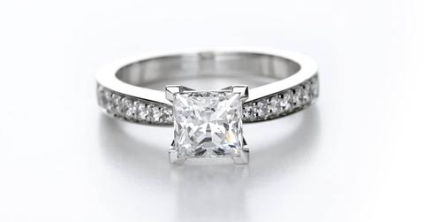 Beautiful engagement ring with a large diamond in the centre piece and tiny diamonds all around the band.