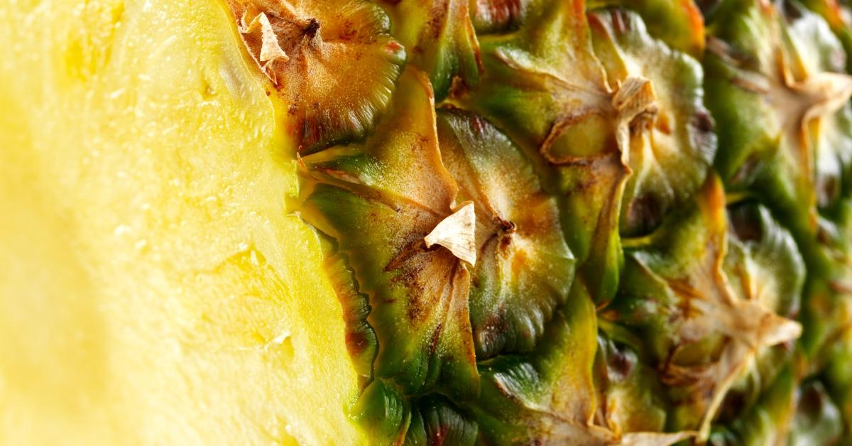 Close-up photograph of slice of pineapple. 