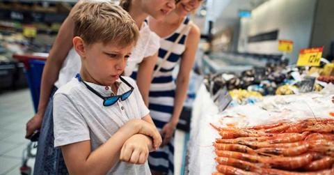 Family with kids walking past a seafood counter, with shrimp, in a supermarket (Representative Cover Image Source: Getty Images | Imgorthand)