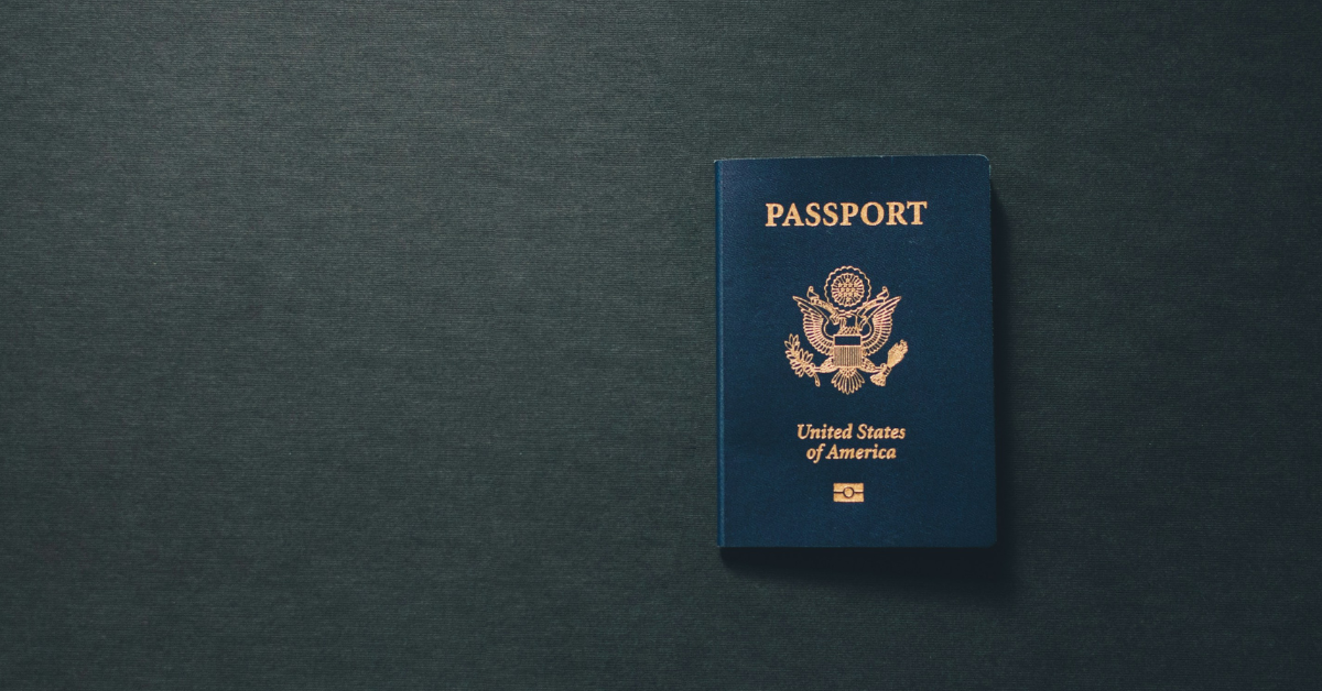 A passport sits against a dark backdrop 