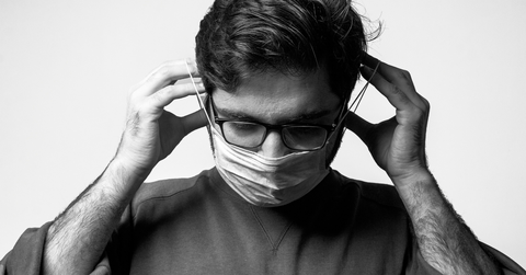 A man puts on a face mask