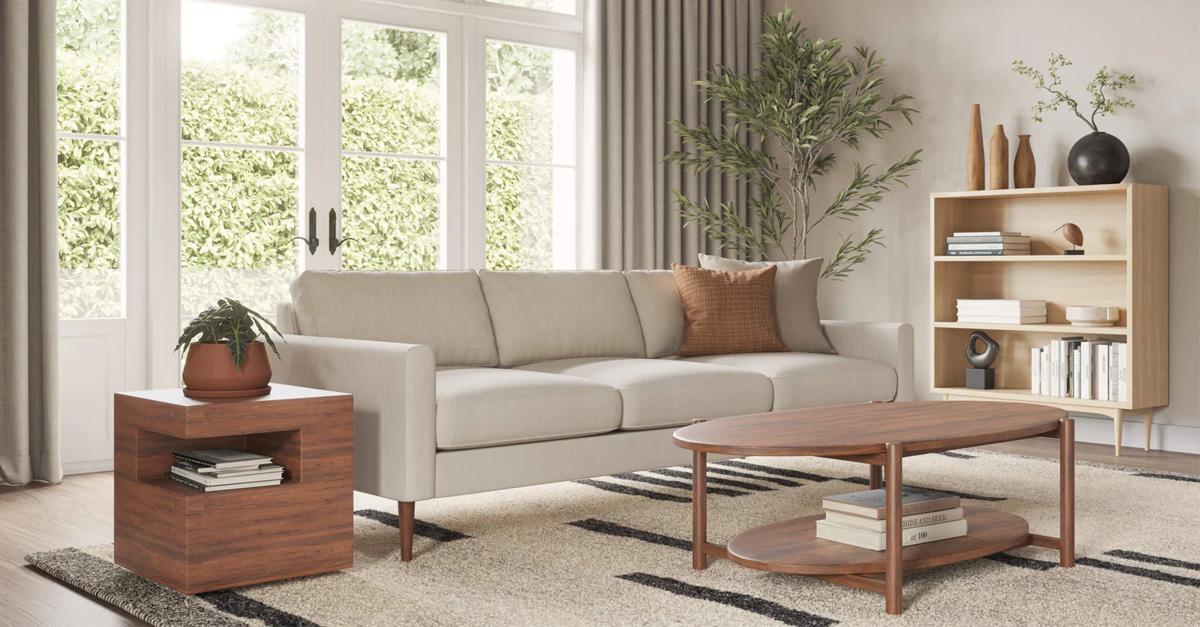 living room with cream sofa and wood tables and shelving with a rug and a view