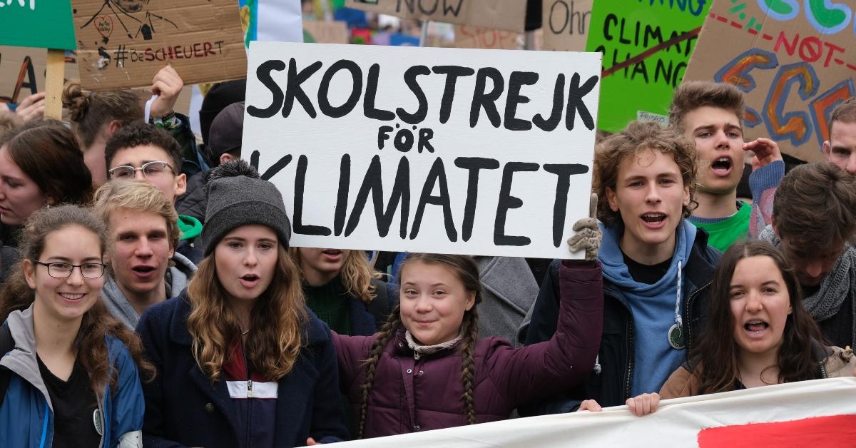 Greta Thunberg holding her School Strike for Climate. 