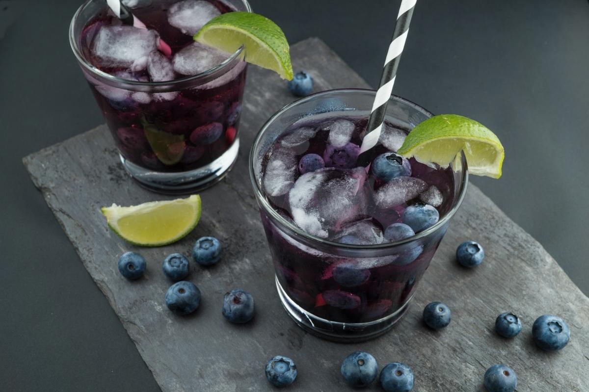 iced blueberry cocktails with lime wedges