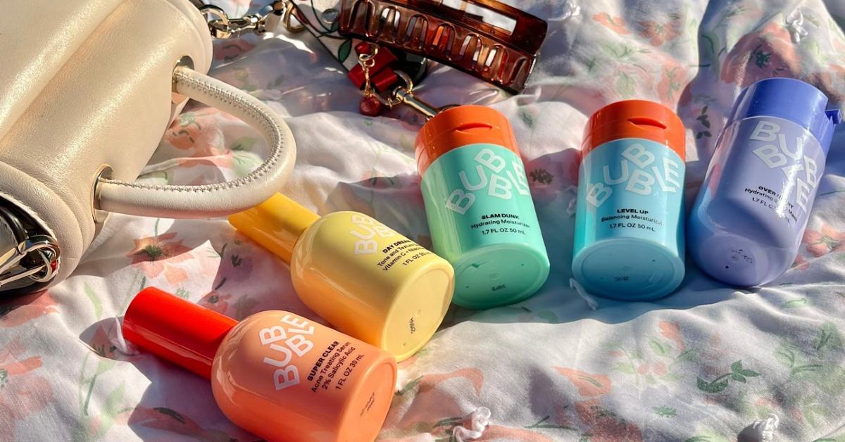 Photo of colorful Bubble skincare products lined up on a picnic blanket