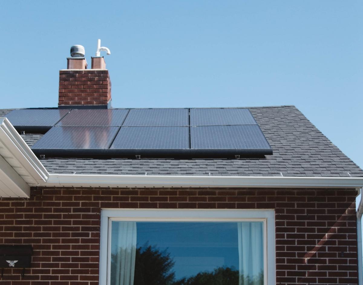 rooftop solar panels on a brick home with brick chimney