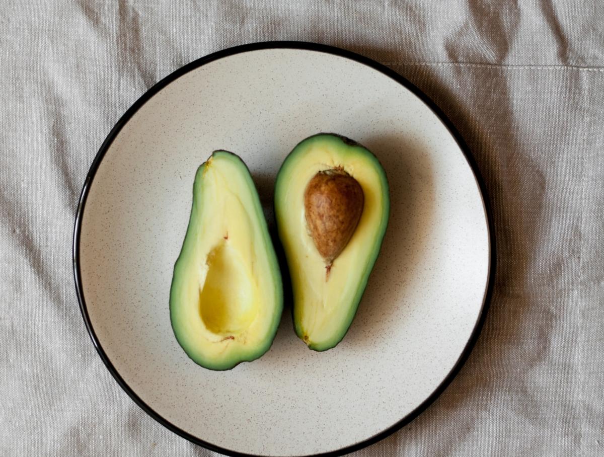 Avocado halves open on a plate