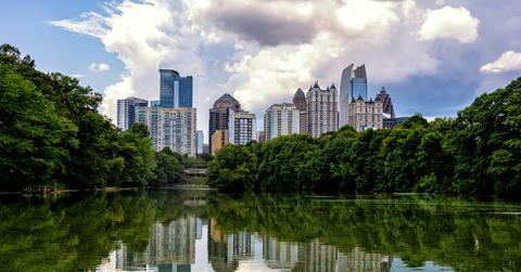 The Atlanta skyline appears behind a reflective lake