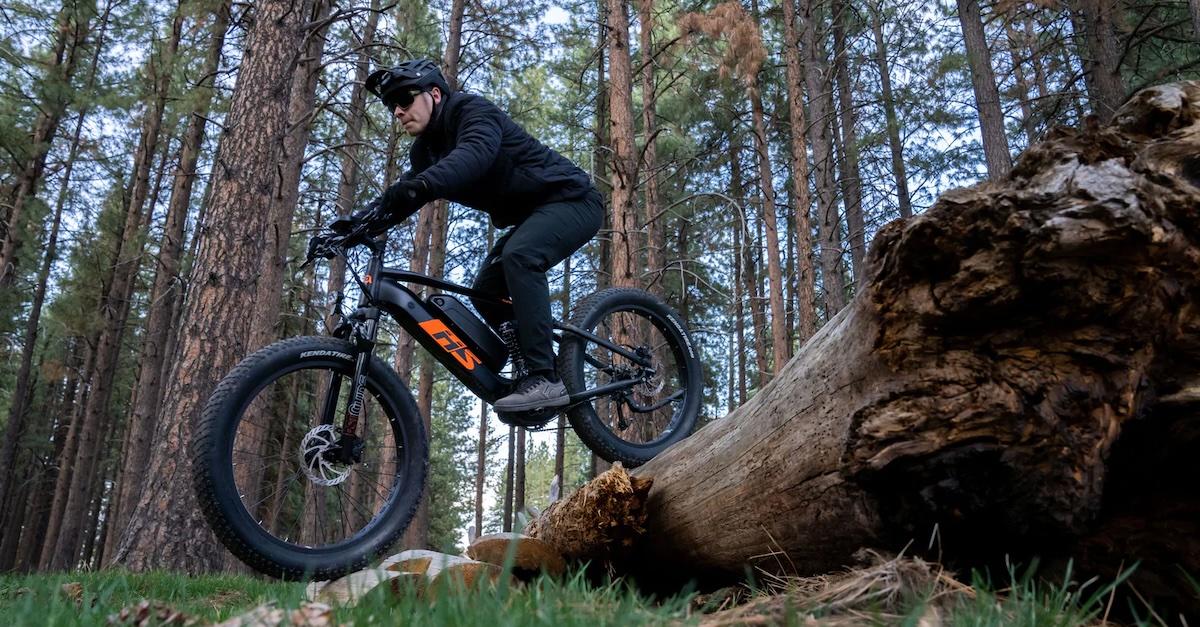 Man rides electric bike by Electric Bike Co. in the woods