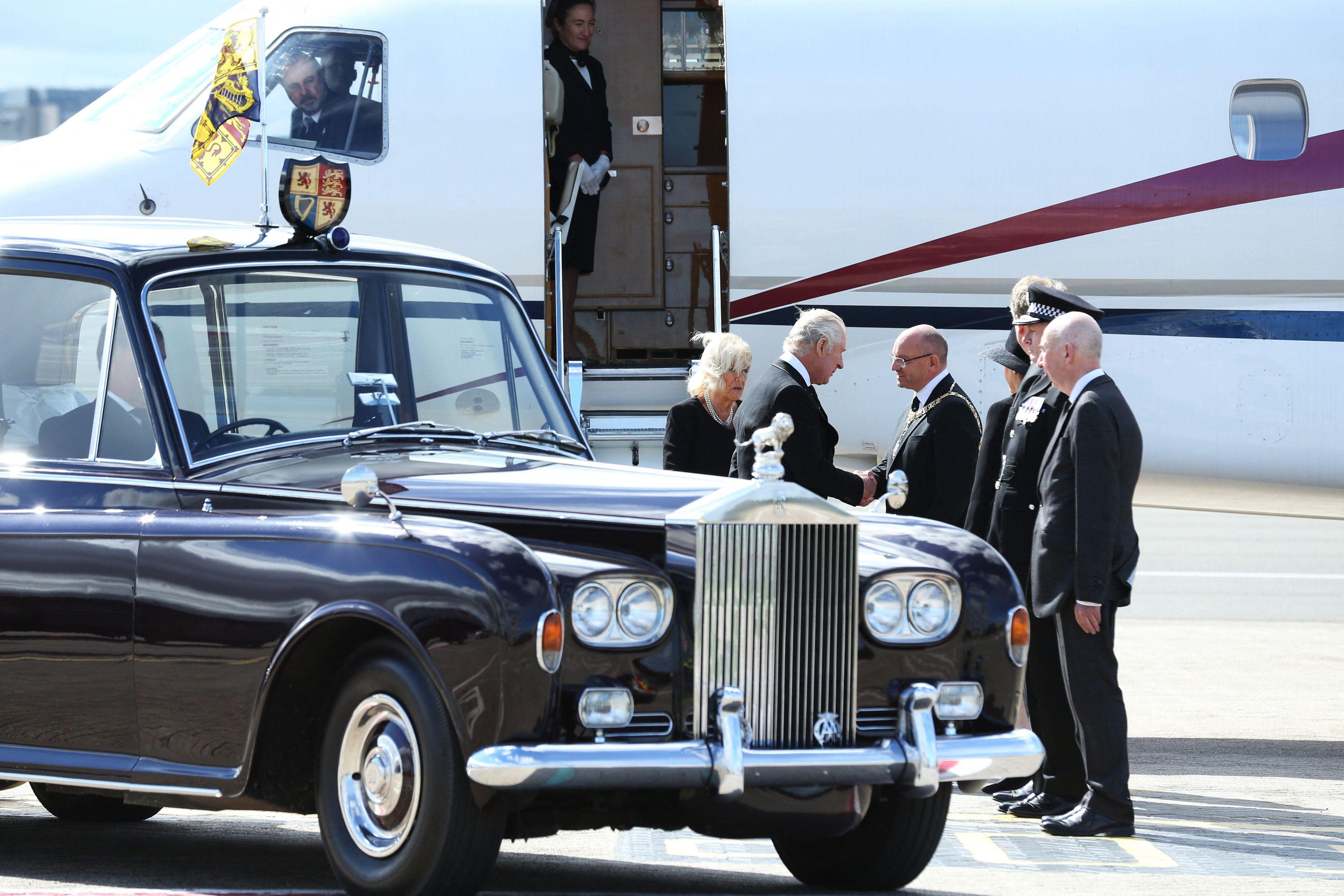 King Charles III leaves the plane carrying him and Queen Camilla at Edinburgh Airport in September 2022.