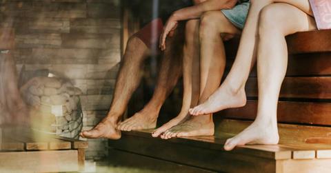 Three friends enjoying the benefits of sauna bathing (view of legs only)