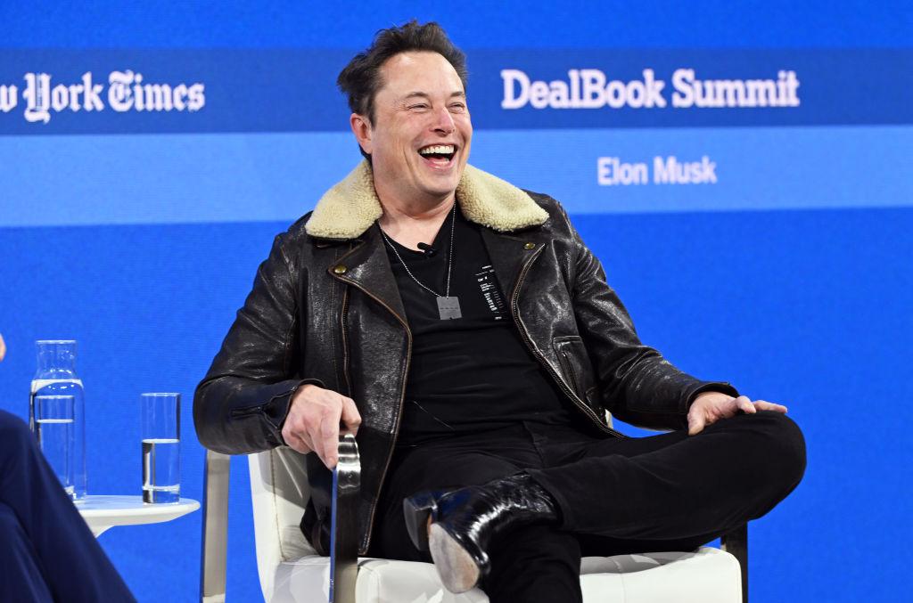 Elon Musk smiles onstage during The New York Times Dealbook Summit 2023 in New York.