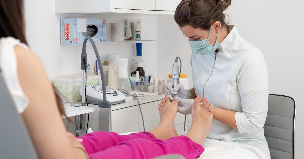 Female podiatrist working on patient's foot