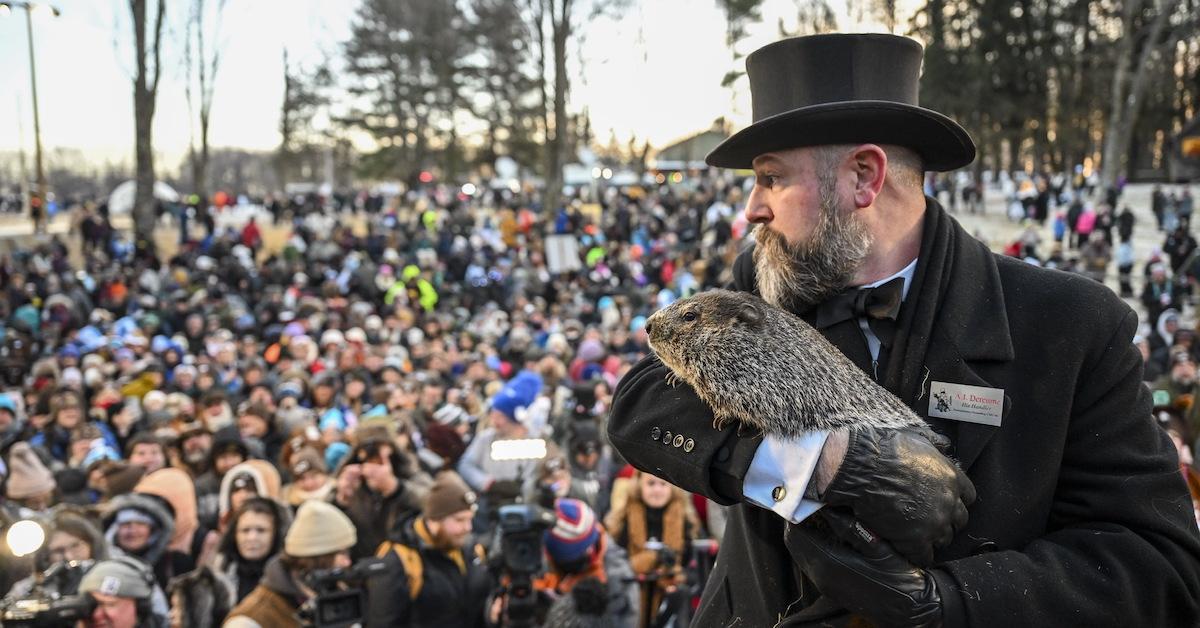 A man in a top hat holds up Punxsutawney Phil before a crowd on Groundhog Day at the Gobbler's Knob in Punxsutawney, Penn. on Feb. 2, 2023. 