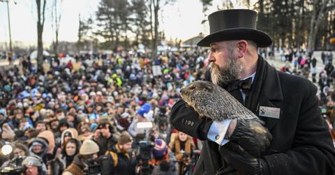 A man in a top hat holds up Punxsutawney Phil before a crowd on Groundhog Day at the Gobbler's Knob in Punxsutawney, Penn. on Feb. 2, 2023.