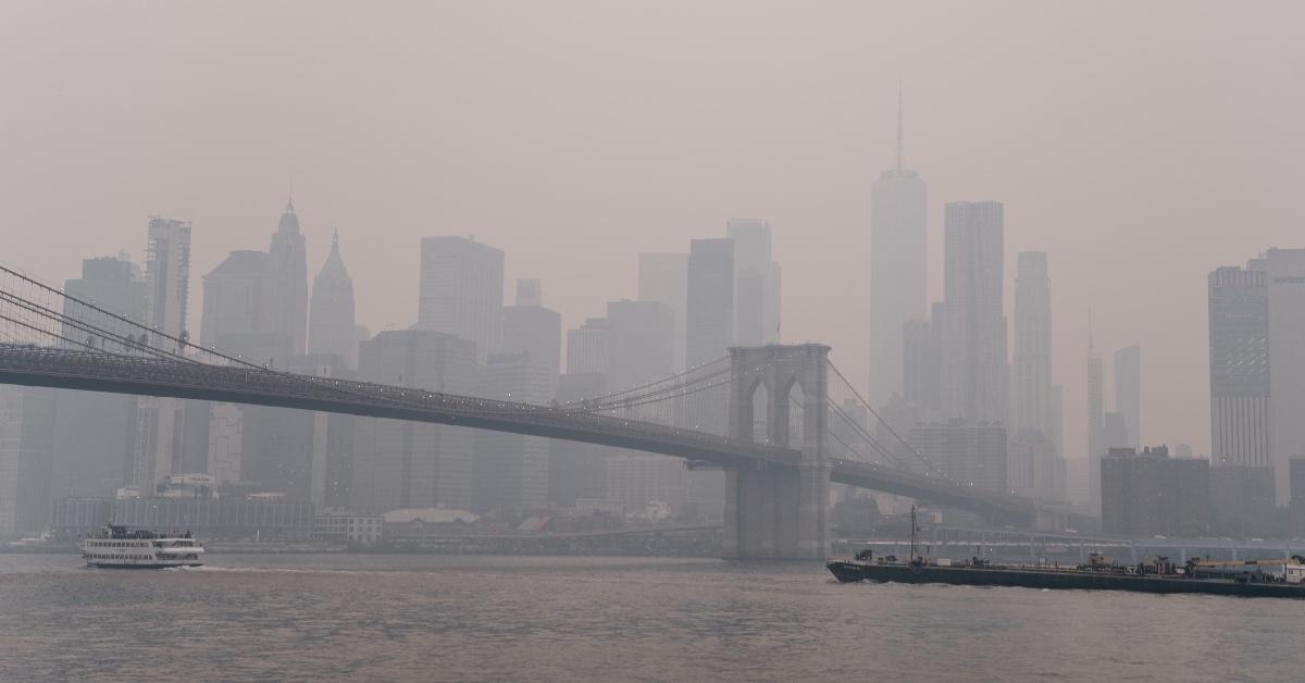 View of the Brooklyn Bridge through the orange haze of the 2023 Canada wildfires. 