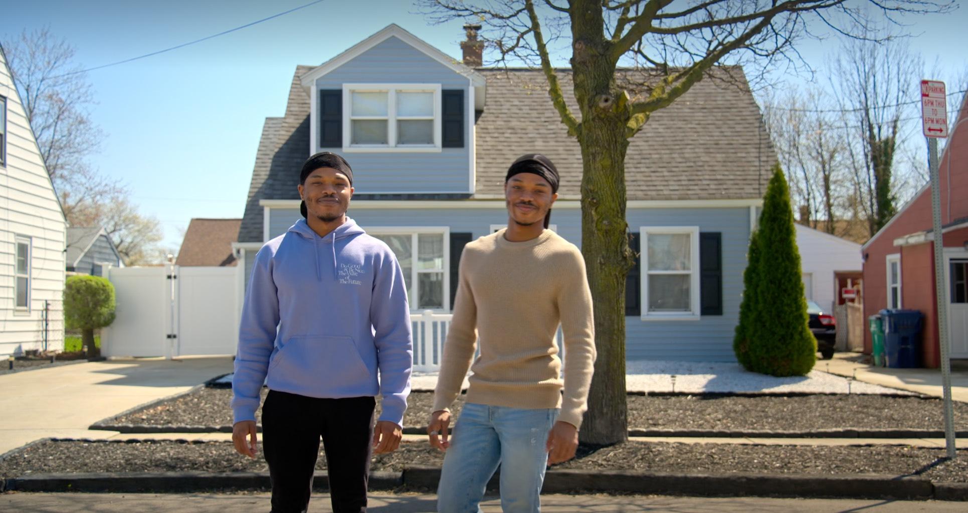 Twins John and Jevon pose together in purple and brown sweatshirts in front of a neighborhood house in the trailer for the new Netflix documentary series in which they star.