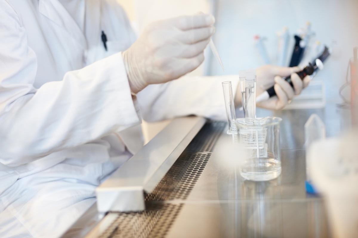 researcher handling test tube vials in lab