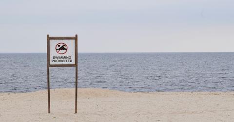A sign alerts visitors at the beach the swimming is prohibited