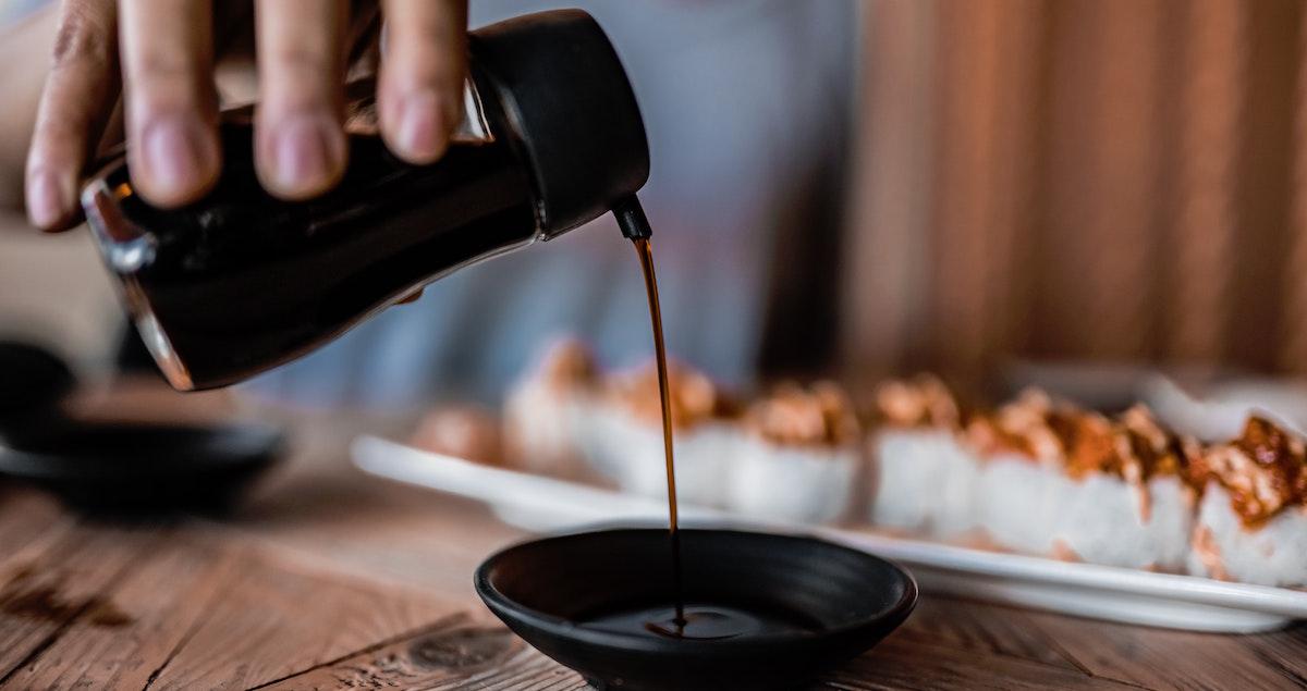 Dark soy sauce being poured