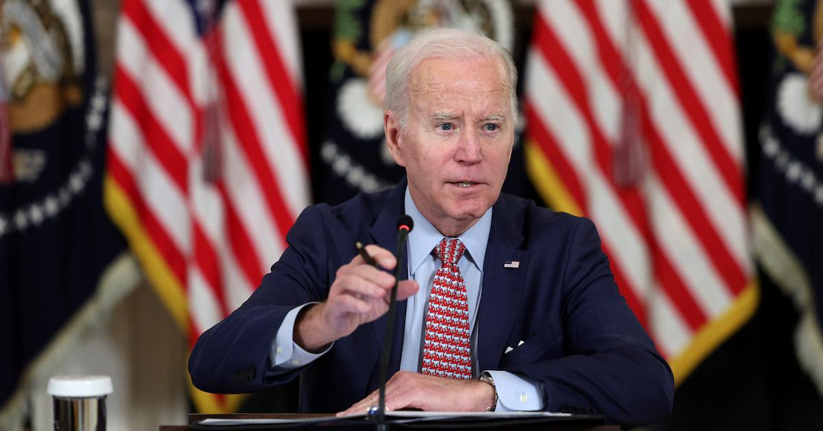 Joe Biden speaks in front of American flags