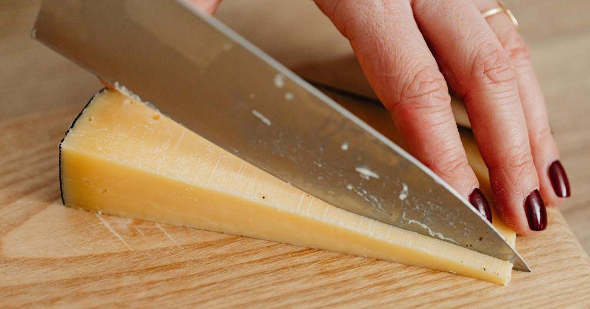 Woman dicing a hunk of cheese (Representative Cover Image Source: Pexels | Karolina Grabowska)