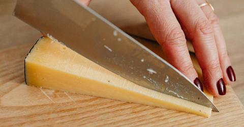 Woman dicing a hunk of cheese (Representative Cover Image Source: Pexels | Karolina Grabowska)