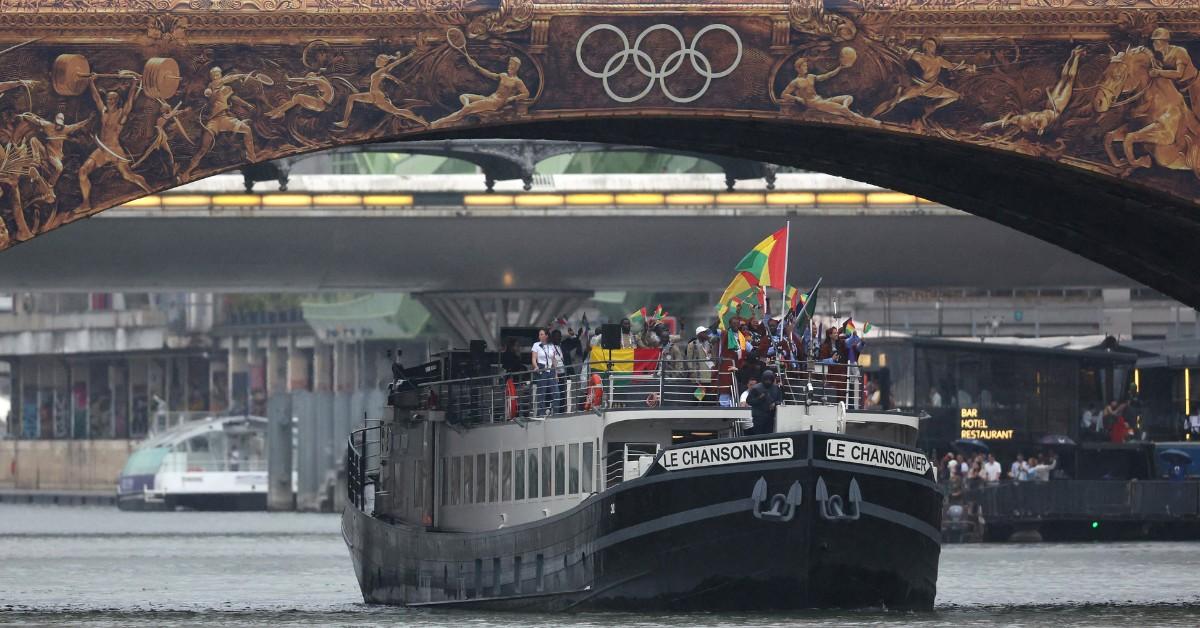 A boat sails down the Seine ahead of the opening ceremonies for the Olympics