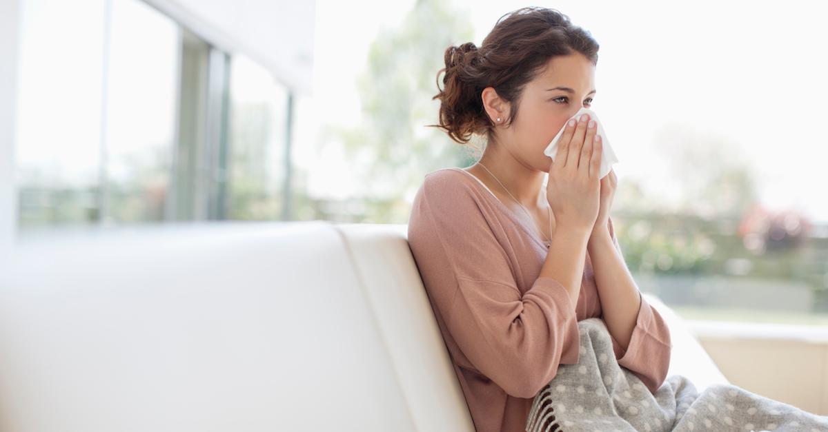 Woman blowing nose