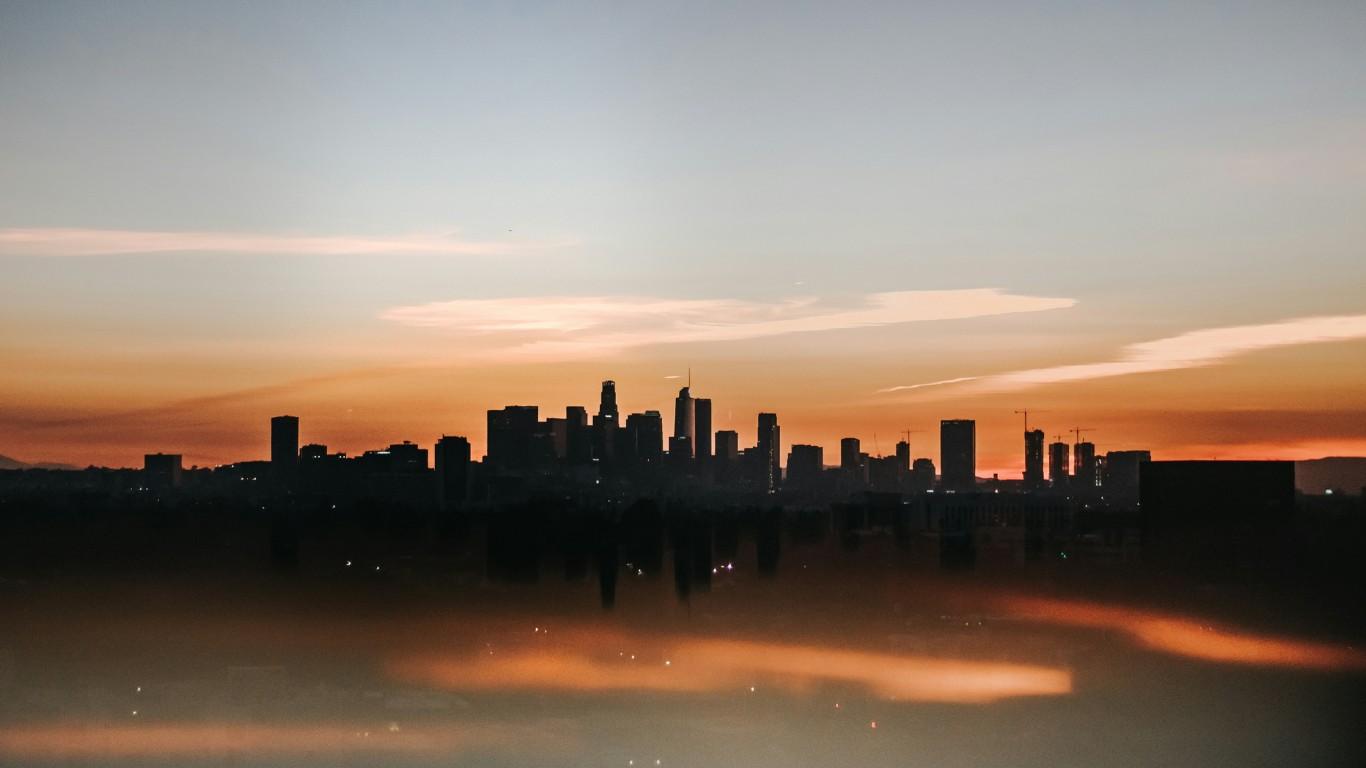 A city skyline appears shrouded in fog from the heat