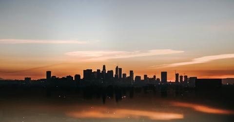 A city skyline appears shrouded in fog from the heat