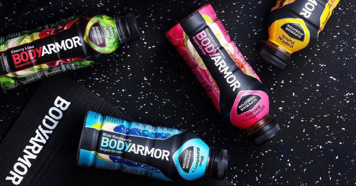 Photo of four bottles of Bodyarmor sports drinks on black background with white speckles 