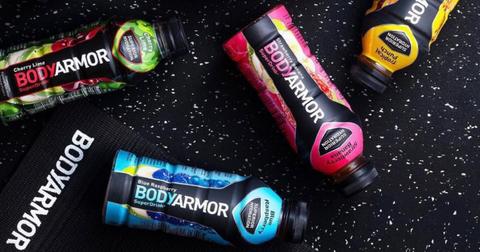 Photo of four bottles of Bodyarmor sports drinks on black background with white speckles