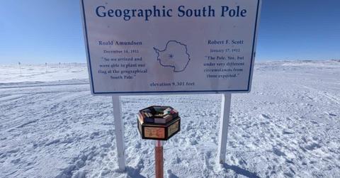 Orname metal marker embedded in Antarctic ice near the Amundsen-Scott South Pole Station to represent the South Pole (Cover Image Source: Facebook | The Antarctican Society/Photo by Sven Lindstrom)