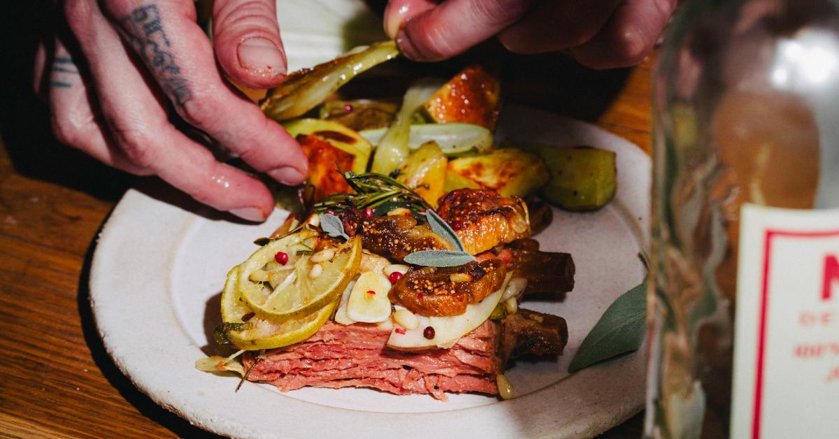 Photo of plant-based meat company Juicy Marbles's Baby Ribs being prepared Mediterranean style by a pair of hands