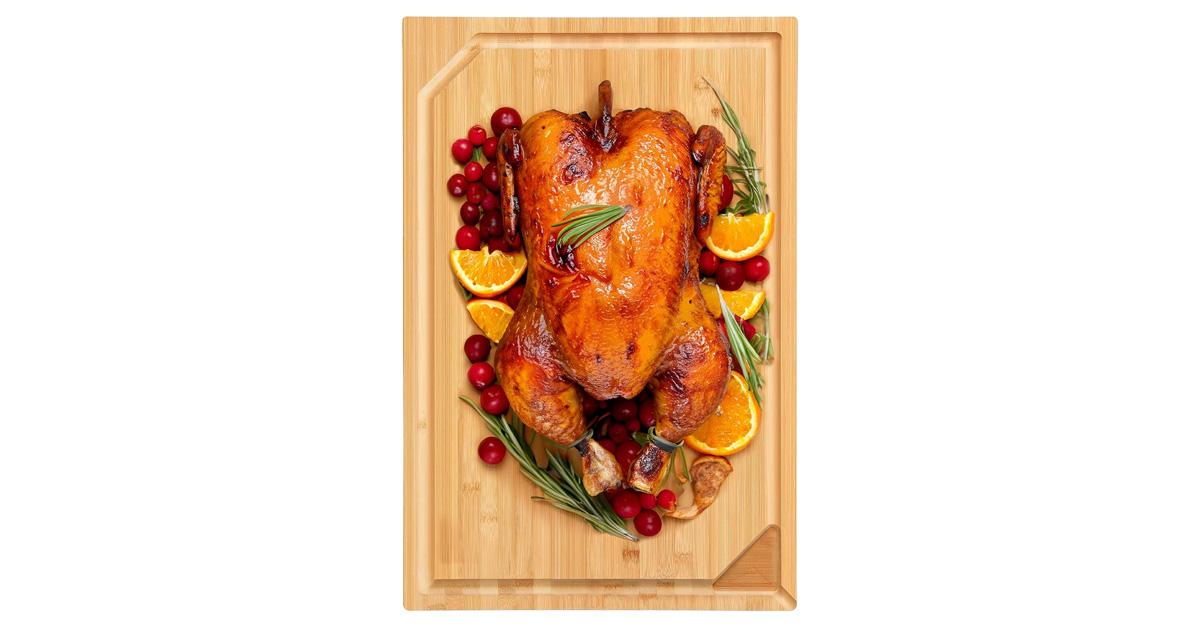 Bamboo cutting board with a turkey and vegetables.