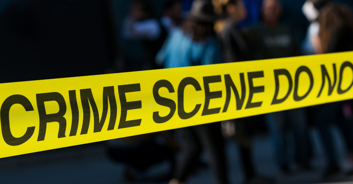 Crime scene tape stretches across a street