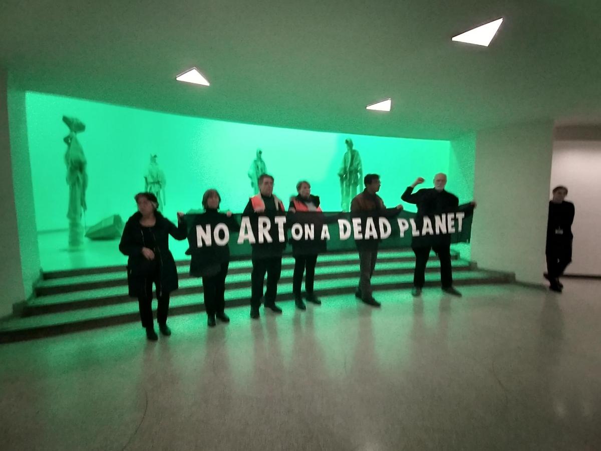 activists holding banner: "No Art On A Dead Planet"